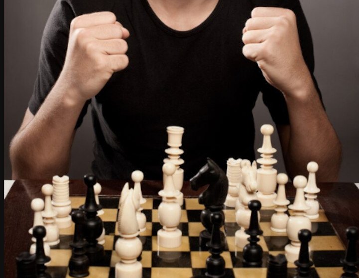Unknown chess player next to checkerboard