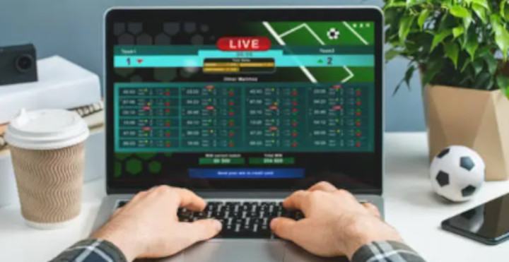 Person Places Online Bets on a Laptop