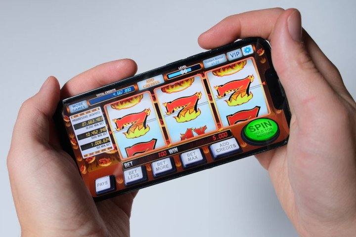 Someone is playing a mobile slot machine game on the smartphone