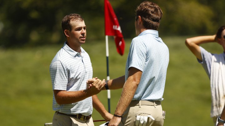 Two golf players handshaking to show respect each other